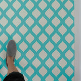 Amina Wall Stencil painted on floor in turquoise.